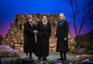 Olive, Woman number 1 and Woman number 2 stand in the hills of Lockerbie at the riverside, contemplating how to obtain the clothing from the victims of the Pan Am tragedy. The are dressed in heavy coats against the Scottish night and stare off towards the audience with expressions that show their obvious frustrations.