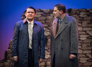 Bill Livingston and George have a conversation in the hills around Lockerbie as Bill tells George of his concern for his wife Madeline who has never found any items of their Son and therefore has never had closure on their loss. Bill is looking at George as George stares out the audience. Conflicted by his sense of duty and the penalties that could be imposed for releasing evidence, and his sense of sadness at the plight of both Madeline and Bill.