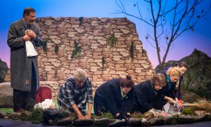 Cast of "The Women of Lockerbie" on stage at the final scene, washing the clothes in the river as Bill Livingston watches on.